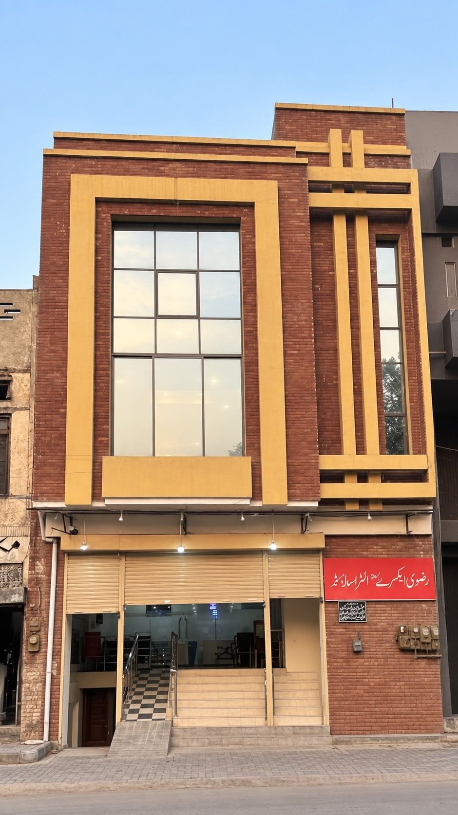 Front of the Rizvi Diagnostics building, showing the entrance steps, the ramp and the red Urdu sign